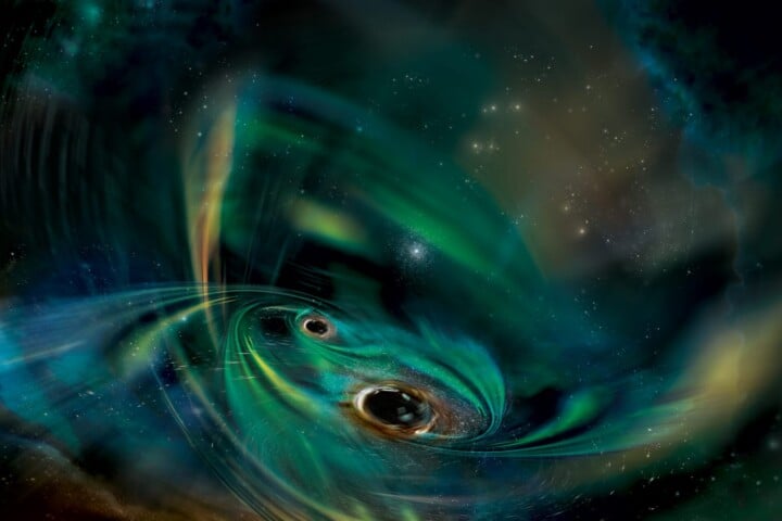 Two black holes are illustrated orbiting in a cloud of gas.